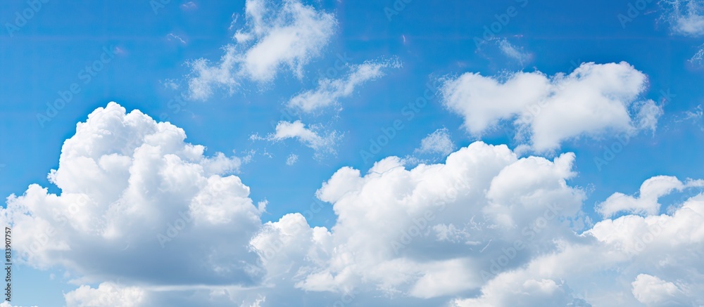 Poster beautiful white fluffy clouds contrasted against a deep blue sky create a serene copy space image.
