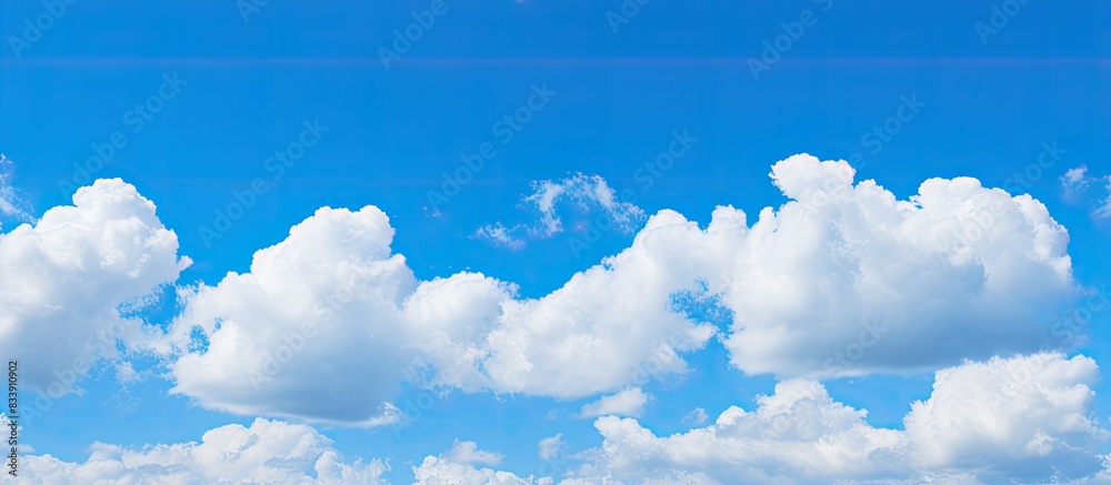 Poster blue sky with fluffy clouds provides a serene copy space image.