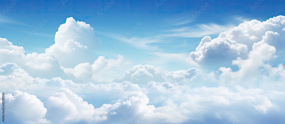 Poster White clouds fill the sky with a backdrop of blue, creating a peaceful and serene atmosphere for any copy space image.