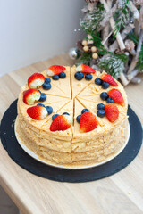 Napoleon cake decorated with fresh berries and fruits. Delicious dessert for any occasion