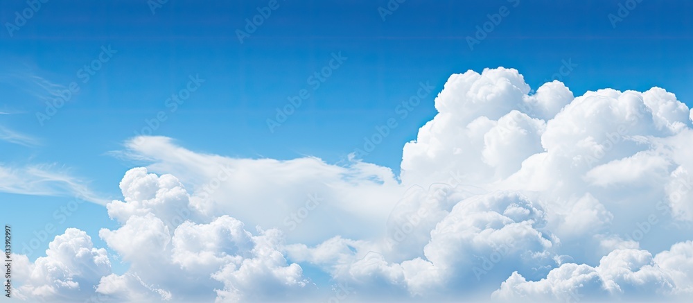 Poster sunny blue sky with a fluffy white cloud in a serene setting, ideal for a copy space image.