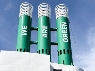 Three ferry funnel chimneys with the slogan we are green on green painted chimneys indicating the use of natural gas in place of deisel oil