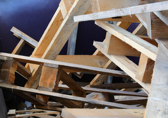 industrial waste container filled with broken wooden pallets ready for recycling at an industrial...