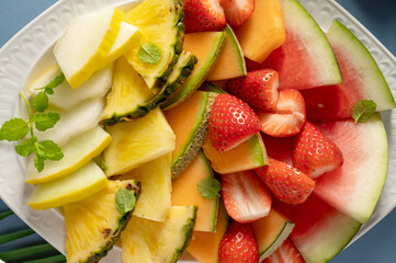 Summer fruits assortment platter antipasti, watermelon, pineapple, melon and strawberries. 