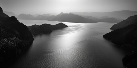 A serene black and white image of a body of water, perfect for use in editorial or commercial contexts