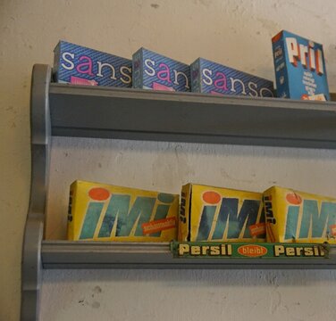 Sanso, Pril und Imi Kartonagen in einem Regal