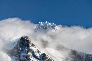 Close up view of snow covered summit Cerro Paine Grande of Cordillera Paine mountain group in Paine...