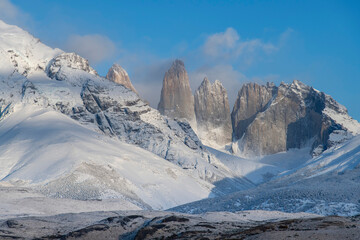 Torres del Paine National Park, Patagonia, Chile; Close up of snow covered Paine Massif mountains with three iconic granite towers (torres) during dawn along the W-trek route