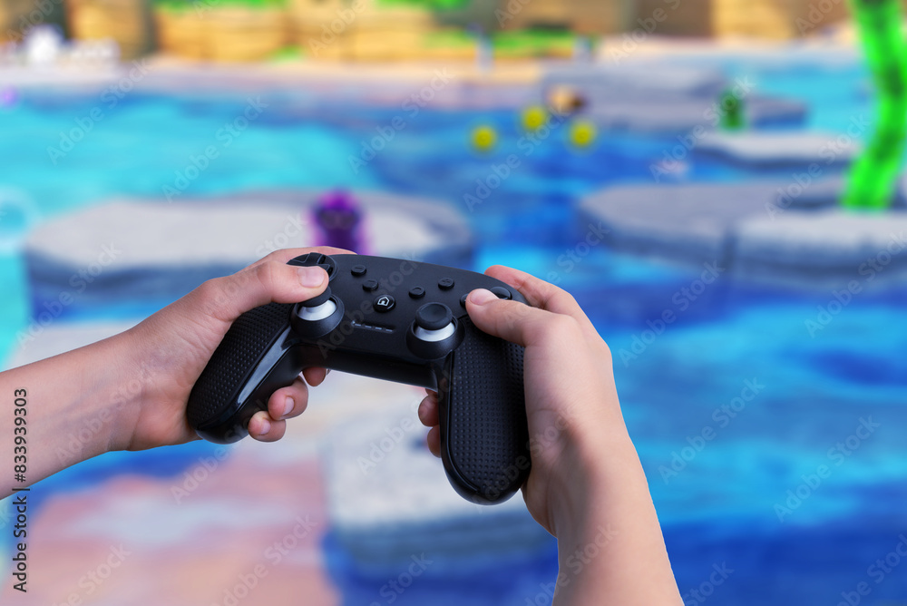 Poster child holding a gamepad with video gameplay on a big screen in the background. gaming, technology, a