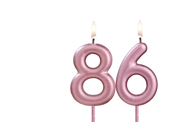 Candle number 86 - Lit birthday candle on white background