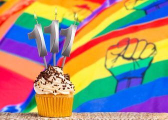 Birthday candle number 111 - Gay march flag background