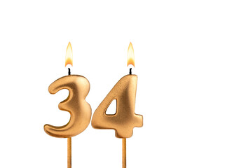 Golden candle number 34 - Birthday on white background