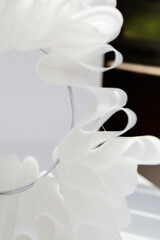 Fototapeta premium White sculptural papercraft lamp. Mid-century modern decor. Close-up photograph.