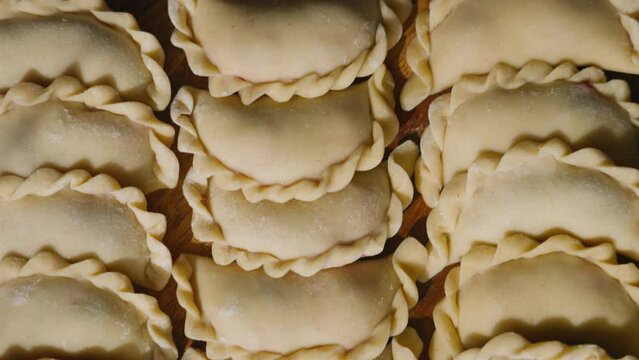 Straight down view on symmetrical and geometrical layout of dumplings on serving board. Delicious food copyspace
