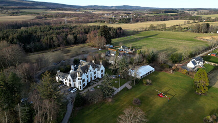 Scotland Countryhouse Castle estate hotel luxury property circling 360 degrees drone aerial overlooking fields sea water countryside sunshine sunlight helicopter parked front © pitrix