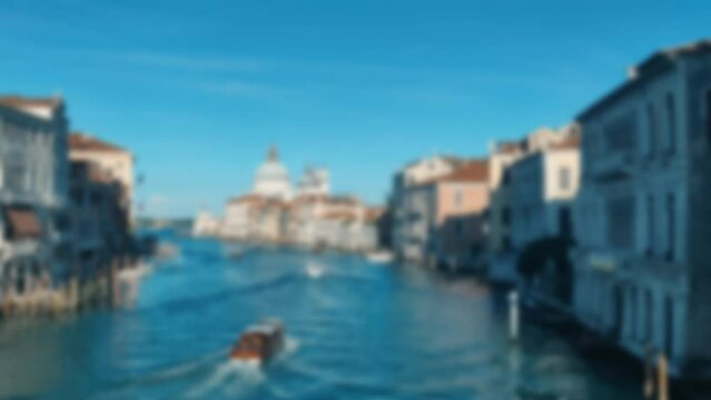 Blurred romantic background Grand Canal in Venice in summer. Gandolas and ships. Italy. 