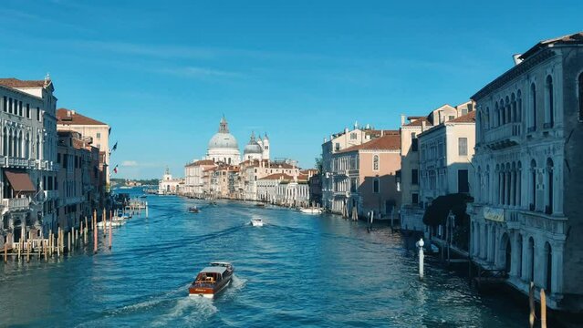 Romantic background Grand Canal in Venice in summer. Gandolas and ships. Italy. 