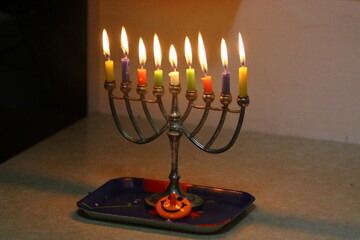 Fototapeta premium A burning wax candle stands on the table.