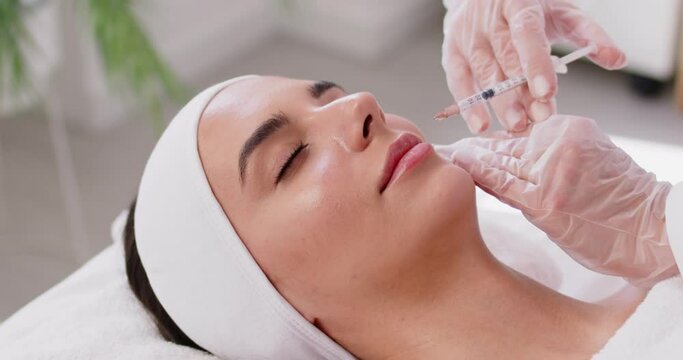 Cheek fillers female cosmetic process, procedure of augmentation, beautiful face close up, syringe, cosmetologist doing facial injection to increase size, cheek volume, lift cheekbones, smooth wrinkle