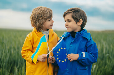 Little cute boys with European union Ukrainian flag in field. Happy children, EU