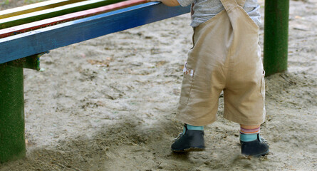 The child near the bench.