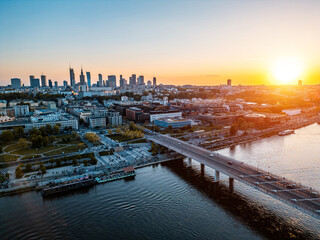panorama of Warsaw city skyline and Vistula river at sunset, skyscrapers of downtown and green...