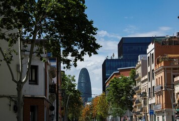 street view in Barcelona with Torre Glories in the distant background