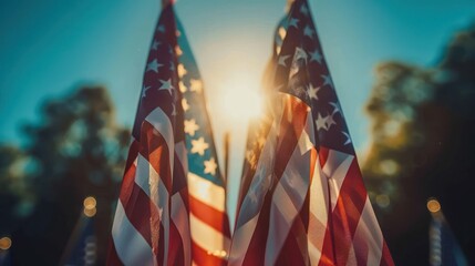 Two American flags with the sun setting behind them creating a patriotic and serene atmosphere, symbolizing freedom and national pride.