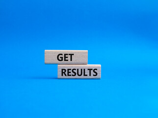 Get results symbol. Wooden blocks with words Get results. Beautiful blue background. Business and Get results concept. Copy space.
