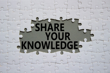 Share your knowledge symbol. Concept word Share your knowledge on white puzzle. Beautiful grey background. Business and Share your knowledge concept. Copy space