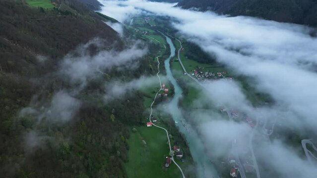 Aerial View Of Idrijca valley from Vrata Cepovan - Beautiful Morning Mist Clouds over River and Towns Connected with Local Road - Slovenia