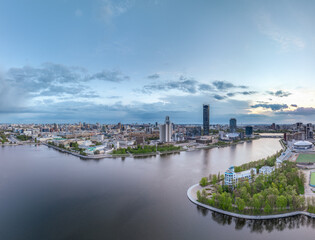 Obraz premium Yekaterinburg city with Buildings of Regional Government and Parliament, Dramatic Theatre, Iset Tower, Yeltsin Center, panoramic view at summer sunset.
