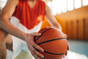 Cropped shot of an unrecognizable man basketball player holding a ball