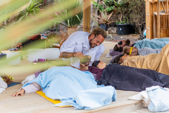 Sound therapy session with a practitioner and participants