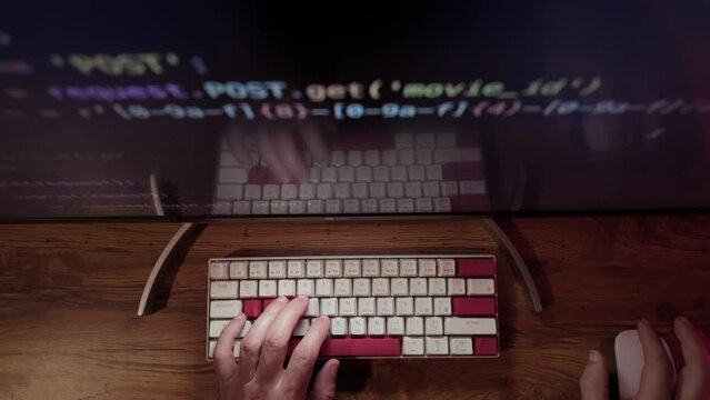 Hands of Professional Programmer is typing code. Top down shot