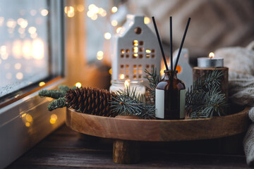 Creating cozy holiday Christmas home atmosphere. Liquid reed diffuser with sticks with xmas scent:...