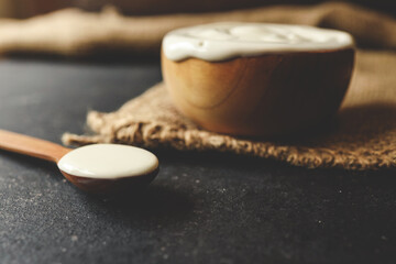 Homemade yogurt or sour cream in a wooden bowl, Health food from yogurt concept