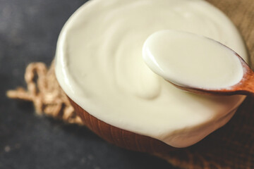 Homemade yogurt or sour cream in a wooden bowl, Health food from yogurt concept