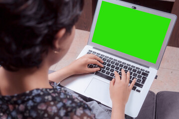 close-up of a woman's hands typing on her laptop, green screen for collage