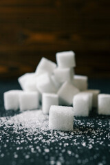White crystal sugar cubes on black background