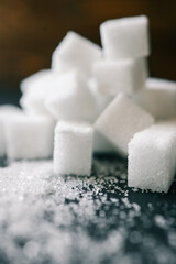 White crystal sugar cubes on black background