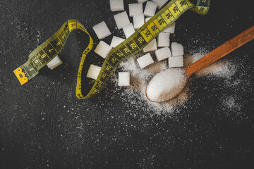 Sugar and measuring tape, health concept