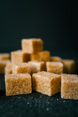 Cane sugar cubes on black background