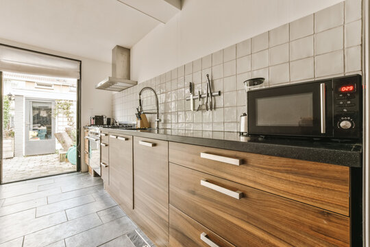 Modern kitchen interior with backyard view in Amsterdam
