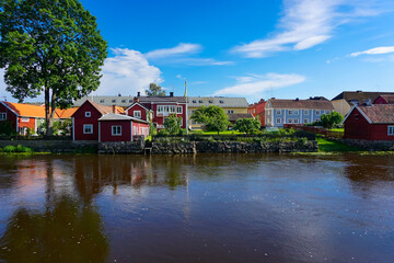 View of buildings by a river against blue sky