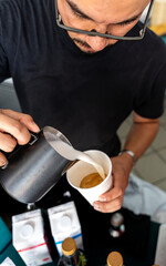 Skilled Barista Crafting Perfect Latte in Modern Coffee Shop