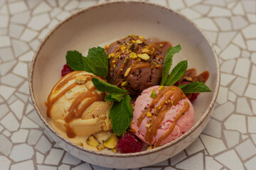 Plate with homemade delicious ice cream. Vanilla, berry and chocolate ice cream. Summer concept, Selective focus