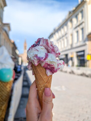 Berry ice cream in woman's hand