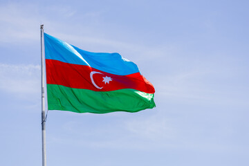 Flag of Azerbaijan is flying in the sky
