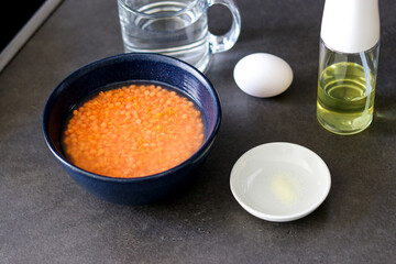 Close up of ingredients for lentils pancake on grey kitchen table